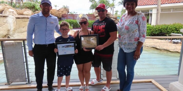 Aruba Tourism Authority Honors Loyal Visitors Mr. Jon & Mrs. Cheri Grinberg and Mr. Anthony Grinberg at Marriott’s Aruba Surf Club