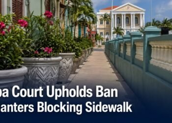 Planters beside a narrow public sidewalk representing an Aruba court ruling