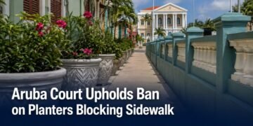 Planters beside a narrow public sidewalk representing an Aruba court ruling
