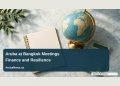 Aruba Central Bank Reviews Bangkok Meetings on Finance and Resilience Conceptual editorial illustration of an overhead arrangement of a blank conference notebook, a plain globe and an unmarked calculator on a light stone table, soft teal daylight, no logos or writing; not a documentary photograph of the people, venue or event.