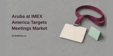 Conceptual editorial illustration of a blank conference badge on a burgundy lanyard beside a mint tent card, with the headline Aruba at IMEX America Targets Meetings Market and ArubaNews.ca branding.
