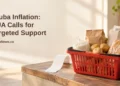 Aruba Inflation: CUA Calls for Targeted Support Conceptual editorial illustration, not actual shop prices or inventory: a basket of unbranded staple groceries and a blank receipt on a wooden counter, with the CUA inflation headline and ArubaNews.ca branding.