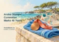 Aruba Olympic Committee Marks 40 Years Conceptual editorial illustration of unmarked sporting equipment and a plain medal against a Caribbean coastal backdrop; not an official Olympic design or a photograph of an anniversary event.
