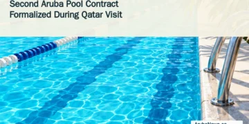 Second Aruba Pool Contract Formalized During Qatar Visit Conceptual editorial illustration of turquoise swimming lanes and a pool ladder, with the article headline and ArubaNews.ca branding; not a design of the planned facility.