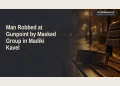 Editorial illustration of an empty wallet on a bench at night; not the Madiki Kavel robbery scene.