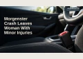 Editorial illustration of a seatbelt buckle and steering wheel in an empty parked car; not the Morgenster crash.