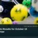 Illustrative stock photo for “Aruba Lotto Results for October 19 Evening Draw”: Lottery balls in a mixing machine. Photo by dylan nolte via Unsplash; not a photograph of the specific event. Headline and ArubaNews.ca branding appear in a lower-third news tile.