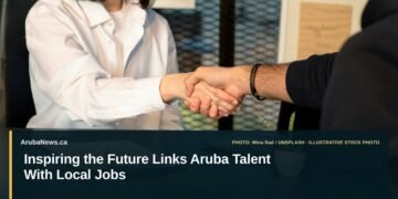 Inspiring the Future Links Aruba Talent With Local Jobs Illustrative stock photo for “Inspiring the Future Links Aruba Talent With Local Jobs”: Two people greeting across a laptop in a job interview. Photo by Mina Rad via Unsplash; not a photograph of the specific event. Headline and ArubaNews.ca branding appear in a lower-third news tile.