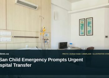 Illustrative stock photo for “ImSan Child Emergency Prompts Urgent Hospital Transfer”: Empty hospital room with bed and desk. Photo by Zoshua Colah via Unsplash; not a photograph of the specific event. Headline and ArubaNews.ca branding appear in a lower-third news tile.