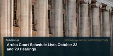 Aruba Court Schedule Lists October 22 and 29 Hearings Illustrative stock photo for “Aruba Court Schedule Lists October 22 and 29 Hearings”: Courthouse-style public building with columns. Photo by Colin Lloyd via Unsplash; not a photograph of the specific event. Headline and ArubaNews.ca branding appear in a lower-third news tile.