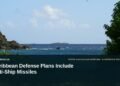 Illustrative stock photo for “Caribbean Defense Plans Include Anti-Ship Missiles”: Caribbean coastal water and rocky shoreline. Photo by Karl Callwood via Unsplash; not a photograph of the specific event. Headline and ArubaNews.ca branding appear in a lower-third news tile.