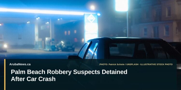 Illustrative stock photo for “Palm Beach Robbery Suspects Detained After Car Crash”: Black sedan parked at a petrol station at night. Photo by Patrick Schiele via Unsplash; not a photograph of the specific event. Headline and ArubaNews.ca branding appear in a lower-third news tile.