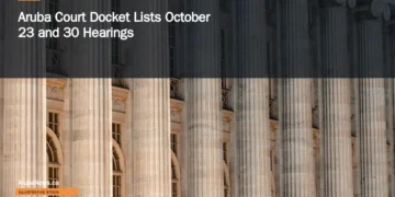Illustrative stock photograph for “Aruba Court Docket Lists October 23 and 30 Hearings”: a large building with columns and a clock on the front of it Photograph by Colin Lloyd via Unsplash. This is not a photograph of the specific Aruba news event.