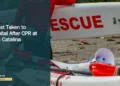 Tourist Taken to Hospital After CPR at Boca Catalina Illustrative stock photograph for “Tourist Taken to Hospital After CPR at Boca Catalina”: 2026-07-10 Vancouver beach lifeguard red jacket carrying surf rescue surfboard. Photograph by Anthony Maw via Unsplash. This is not a photograph of the specific Aruba news event.
