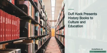 Illustrative stock photograph for “Dufi Kock Presents History Books to Culture and Education”: a long row of books in a library Photograph by Zetong Li via Unsplash. This is not a photograph of the specific Aruba news event.