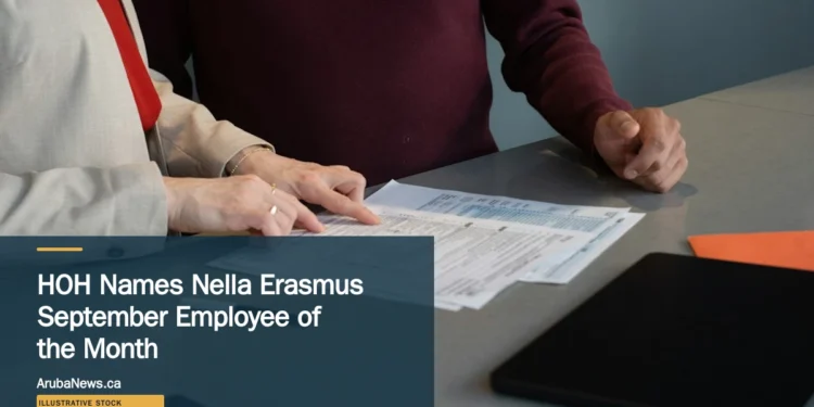 Illustrative stock photograph for “HOH Names Nella Erasmus September Employee of the Month”: Two professionals reviewing paperwork at a conference table during a business meeting in San Francisco. Photograph by Olena Kholina via Unsplash. This is not a photograph of the specific Aruba news event.