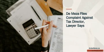 De Meza Files Complaint Against Tax Director, Lawyer Says Illustrative stock photograph for “De Meza Files Complaint Against Tax Director, Lawyer Says”: Financial paperwork; illustrative legal-process stock, not actual complaint files. Photograph by Kelly Sikkema via Unsplash. This is not a photograph of the specific Aruba news event.