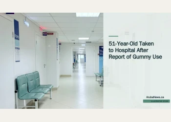 Illustrative stock photograph for “51-Year-Old Taken to Hospital After Report of Gummy Use”: Empty hospital corridor with benches and doors Photograph by Tasha Kostyuk via Unsplash. This is not a photograph of the specific Aruba news event.