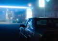 Palm Beach Robbery Suspects Detained After Car Crash Illustrative stock photo for “Palm Beach Robbery Suspects Detained After Car Crash”: Black sedan parked at a petrol station at night. Photo by Patrick Schiele via Unsplash; not a photograph of the specific event.
