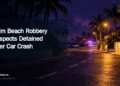 Editorial illustration for Palm Beach Robbery Suspects Detained After Car Crash: Conceptual night street with distant emergency lights; no suspects or crash shown. ArubaNews.ca branding.