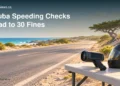 Conceptual editorial illustration of a roadside speed-monitoring device beside a sunlit Aruba road; not a photograph of the reported police operation.