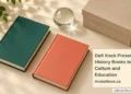 Dufi Kock Presents History Books to Culture and Education Conceptual editorial still life of two blank hardback books, an archival box and glass paperweight, with the article headline and ArubaNews.ca branding; not the actual donated book covers.