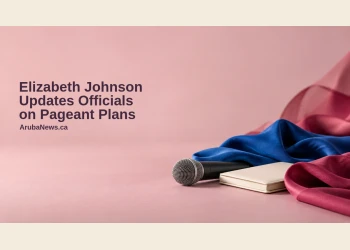 Conceptual editorial still life of an unbranded microphone, closed notebook and blue and raspberry fabrics on a pink surface, with the Elizabeth Johnson headline and ArubaNews.ca branding; not a photograph of Johnson or an actual briefing.