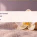 Conceptual editorial still life of a white orchid and seashell; not a portrait or photograph of the funeral.