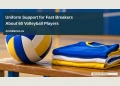 Aruba Bank Backs Uniforms for About 60 Fast Breakers Players Conceptual editorial illustration of a volleyball beside neatly folded plain sports jerseys on an empty indoor court bench, low angle with bright blue and yellow accents, no logos, numbers, people or recognizable venue; not a documentary photograph of the people, venue or event.