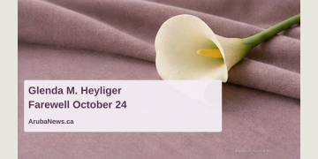 Editorial memorial illustration of an ivory calla lily on fabric; not a photograph of Glenda M. Heyliger or the funeral venue.