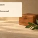 Family Announces Death of John Otmar Harewood Conceptual memorial illustration of an unmarked wooden keepsake box, an unlit candle and green leaves on a sandy tabletop, with the article headline and ArubaNews.ca branding; no portrait or documentary scene.