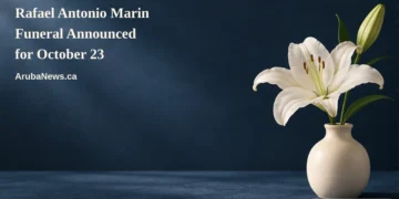 Rafael Antonio Marin Funeral Announced for October 23 Conceptual memorial illustration of a white lily in a plain cream vase on a midnight-blue tabletop, with the article headline and ArubaNews.ca branding; no portrait or documentary scene.