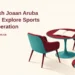 Sheikh Joaan Aruba Talks Explore Sports Cooperation Conceptual editorial illustration of two empty contemporary meeting chairs beside an unbranded swimming lane rope and a blank sports planning notebook, with the article headline and ArubaNews.ca branding.